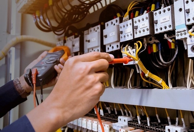 Electrician testing circuits in a Northampton property