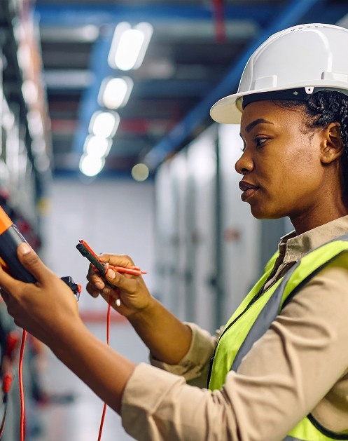 Electrician using a test meter during PAT testing in Northampton